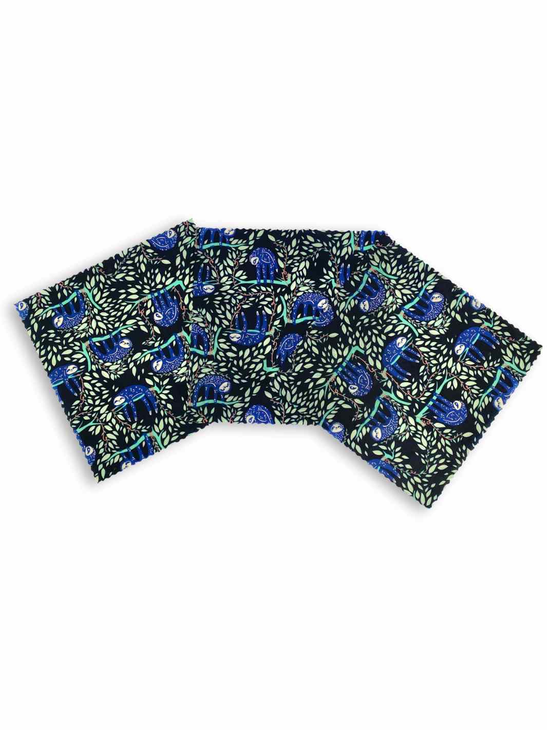 Good Soul Shop Set of three 8-inch beeswax food wraps fanned out in a purple black sloth pattern